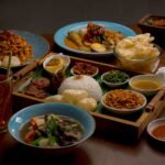 Food and culture travel guide scene featuring colorful local dishes at a bustling market table