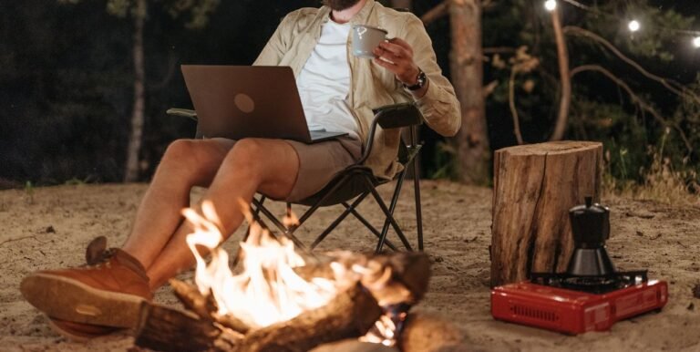 best digital nomad cities enjoying a night working remotely by a campfire