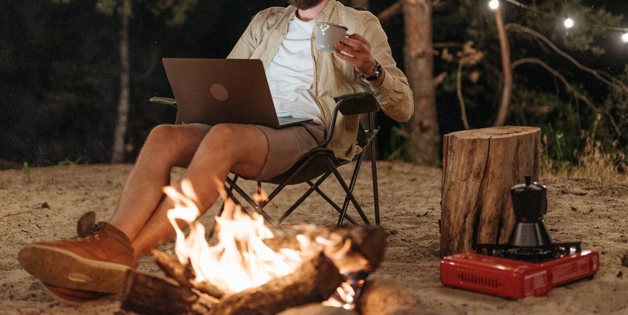 best digital nomad cities enjoying a night working remotely by a campfire
